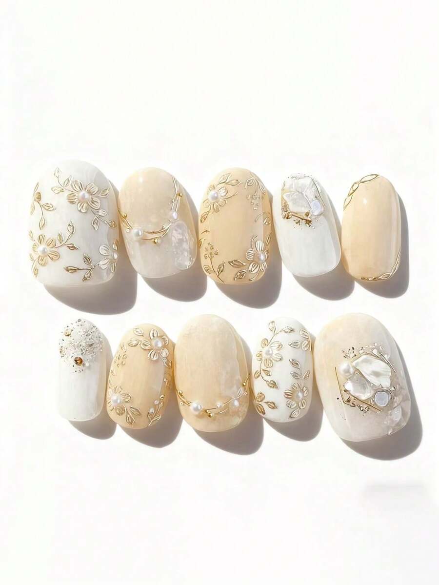 10片纯手工制作的中长椭圆形美甲贴片，黄白相间的猫眼图案，饰以金色小花，可爱精致，柔和闪亮，优雅迷人，适合女性和女孩，春夏秋冬皆宜，节日及日常使用。 - 黃色 - 查看 1