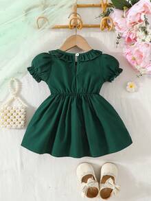 Đầm mùa hè dễ thương in hoa, cổ tròn, tay phồng, trang trí nơ. - Màu xanh lá cây đậm - Xem 2