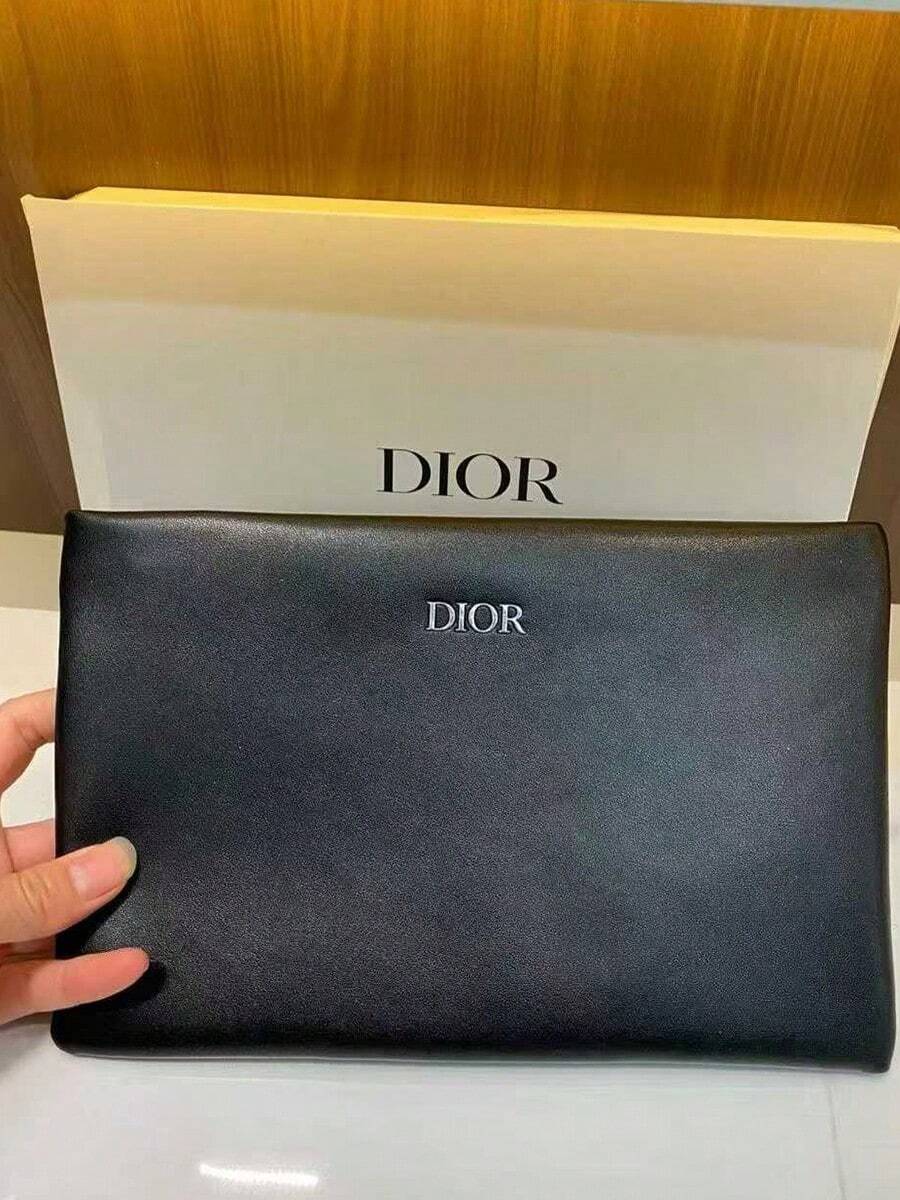 Dior 这款别致的黑色迪奥皮革手拿包饰有品牌标志，尽显奢华美感。无论是出席时尚晚宴还是日常使用，它都是必备单品，完美搭配前卫或优雅的服饰。对于追求高端设计的包袋爱好者来说，这是一款不可错过的精致之作。 - 黑色 - 查看 1