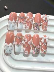 Bộ 10 móng giả cao cấp kiểu dáng cô gái ngọt ngào, được vẽ tay tỉ mỉ, đính nơ 3D và kim cương lấp lánh, kiểu móng Pháp thủ công, thích hợp cho những buổi trà chiều cùng bạn bè, hẹn hò đôi, ngày Valentine và ngày đầu năm mới. - Màu Hồng baby - Xem 4