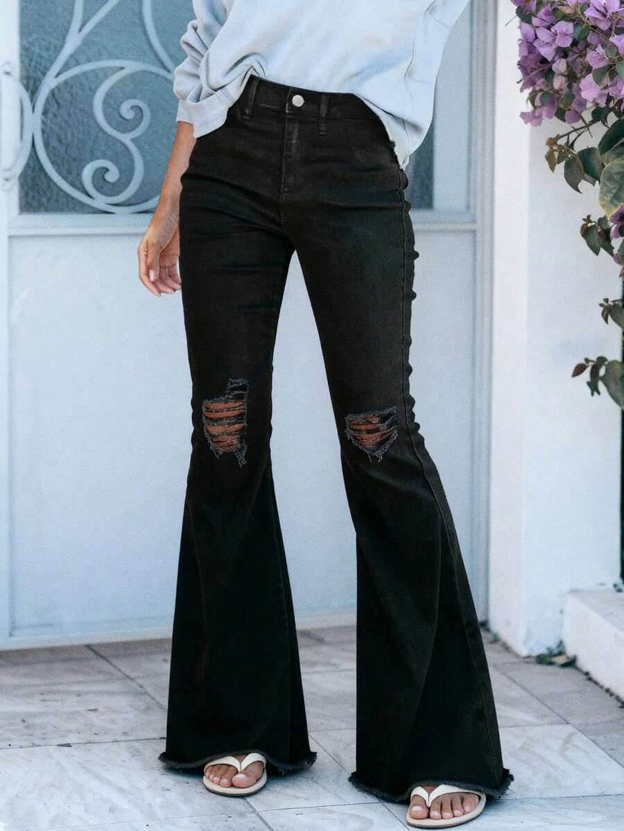 撕破原始下摆喇叭腿牛仔裤，女式纽扣、口袋、原始下摆、撕破、拉链高腰喇叭腿超长黑色常规版型女式牛仔裤，春季/秋季，休闲日常穿着