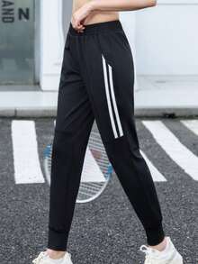 Calça de corrida feminina de cintura alta, com bolsos inclinados, modelo minimalista de cor sólida e corte afunilado, com listras pretas e brancas e cintura elástica. - Preto e Branco - Ver 2