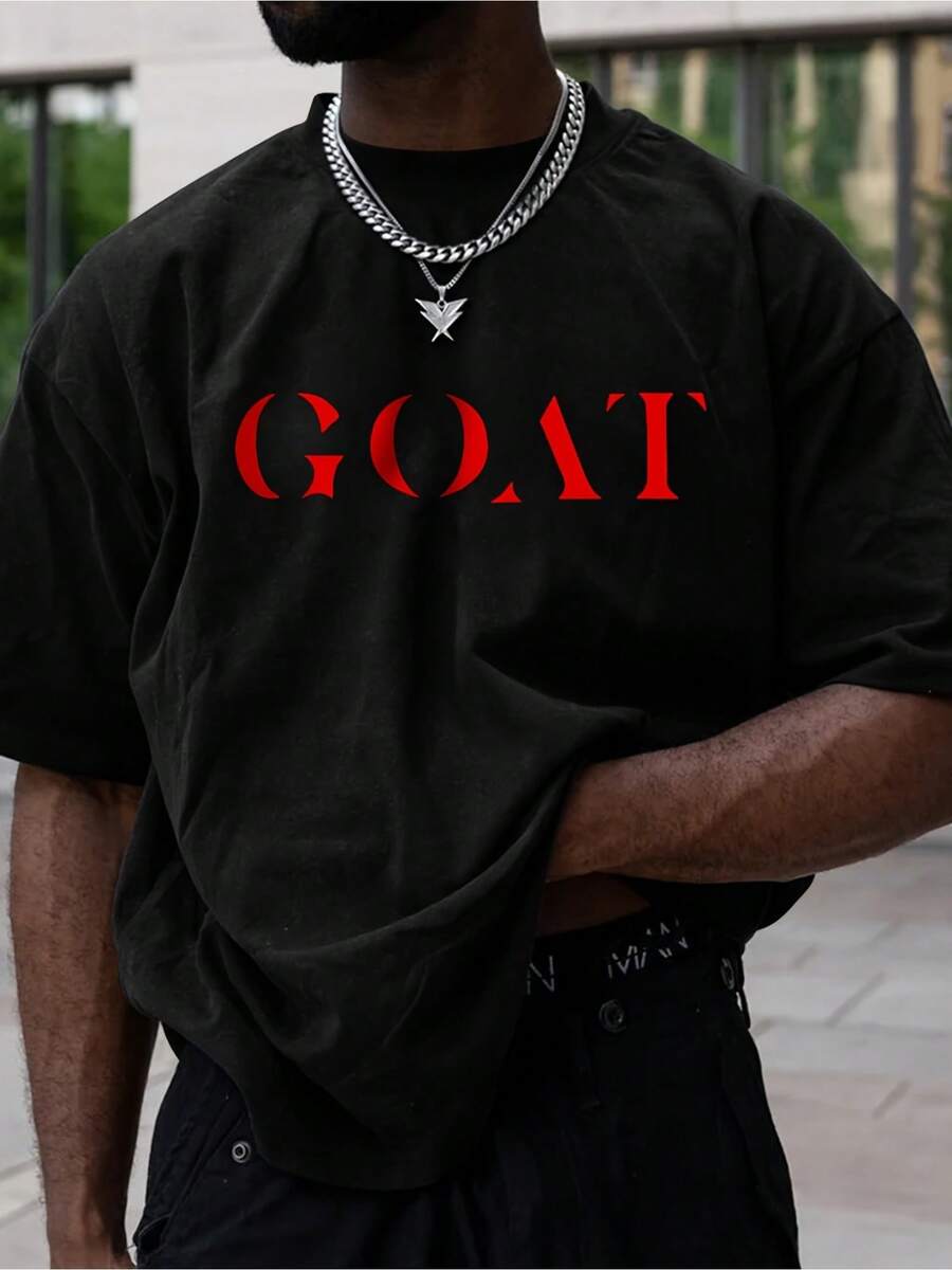 [Durable] Camiseta Gráfica "GOAT" para Hombre - Elegante en Negro con Letras Rojas, Camiseta Casual de Manga Corta con Cuello Redondo, Tejido de Algodón, Lavable a Máquina para Todas las Temporadas, Camiseta Casual a la Moda|Camiseta con Diseño Gráfico Atrevido|Ajuste Cómodo - Negro - Ver 1