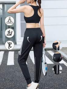 Calça de corrida feminina de cintura alta, com bolsos inclinados, modelo minimalista de cor sólida e corte afunilado, com listras pretas e brancas e cintura elástica. - Preto e Branco - Ver 8