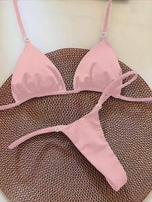 Bộ bikini tam giác màu trơn dành cho nữ, điểm nhấn là vòng tròn hình trái tim. Thiết kế cúp ngực tam giác, dây mảnh, ngọt ngào nhưng vẫn thời trang. Thích hợp cho kỳ nghỉ. - Hồng - Xem 1