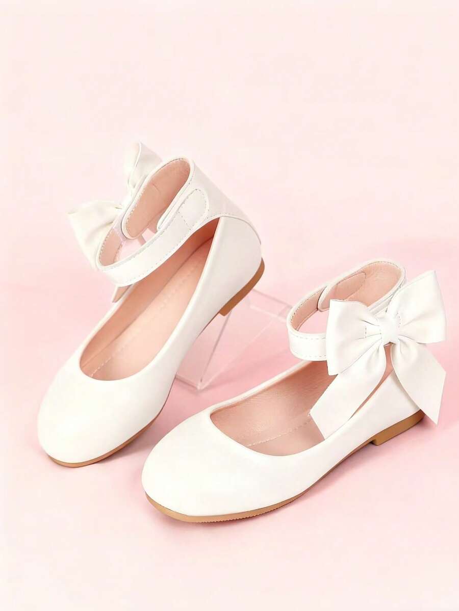 Giày búp bê trẻ em có quai buộc cổ chân và nơ trang trí, thể hiện phong cách giày thanh lịch. - trắng - Xem 1