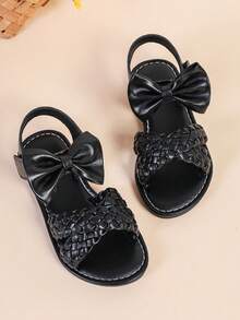 1 par de sandalias planas de color negro para niñas y niños de talla grande, de 3 a 15 años, con decoración de lazo grande tejido de unicolor, cierre con correa, punta redonda y abierta, sandalias romanas de moda y lindas, adecuadas para uso casual, fiesta, viaje, primavera/verano 2025