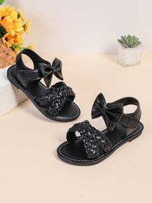 1 par de sandalias planas de color negro para niñas y niños de talla grande, de 3 a 15 años, con decoración de lazo grande tejido de unicolor, cierre con correa, punta redonda y abierta, sandalias romanas de moda y lindas, adecuadas para uso casual, fiesta, viaje, primavera/verano 2025