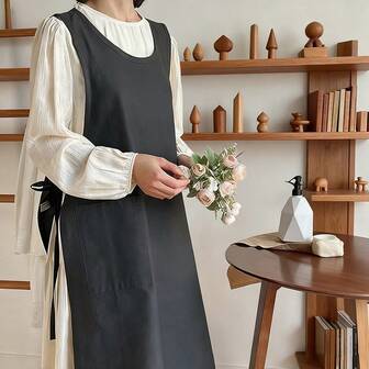 Modernt svart ärmlöst förkläde - Lämplig för användning i köket, blomsterkonst och heminredning, dess snygga design är perfekt för kvinnor att bära.