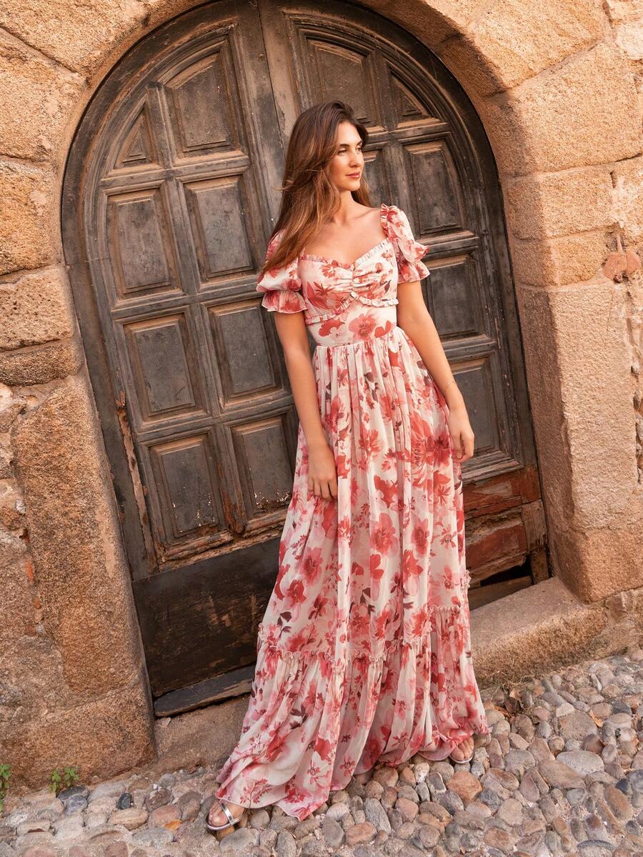 Faeriesty 这款优雅的印花雪纺长裙采用露肩设计，肩部饰有荷叶边，泡泡短袖凸显腰线。多层荷叶边裙摆使其适合夏季婚礼、花园早午餐、海滩郊游和户外下午茶等场合。春季派对的理想之选 - 西瓜粉 - 查看 1