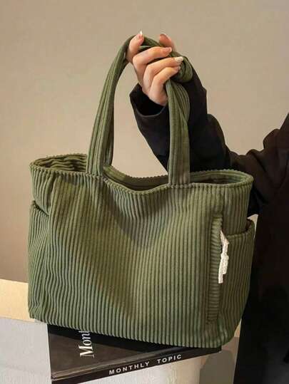 大容量时尚单肩手提包，柔软灯芯绒材质，带侧袋和多个内部隔层，拉链封口，适合短途旅行、通勤和日常使用笔记本电脑。（由于拍摄时的光线和角度原因，实际产品颜色可能与图片略有差异。）