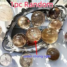 这颗罕见而精致的烟晶球，拥有美丽的半透明纹理和彩虹般的光泽，中心还有一个彩虹形状的孔洞。它是高端珠宝制作的理想之选，也是完美的家居装饰艺术品，更是圣诞节、感恩节和其他节日的独特礼物。 - 1 pc random - 查看 13