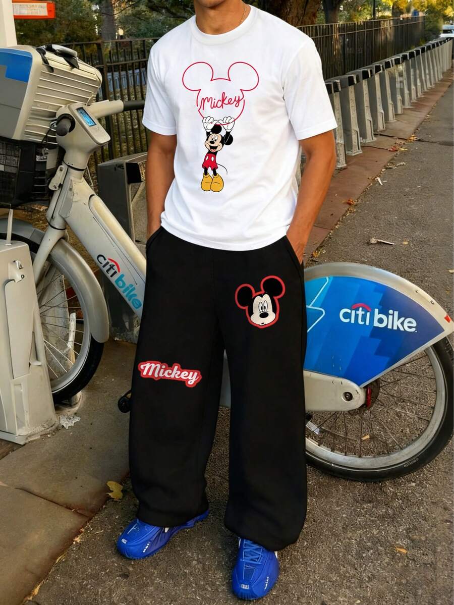 Disney Valentine's Day Pajama Gift Set. Men's Apparel. Mickey Mouse Graphic Tee With Mickey Shaped Ring Pattern. White Short Sleeve T-Shirt Paired With Black Casual Sweatpants. Men's 2-Piece Set. Men's Autumn Outfit