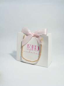 5个优雅的开斋节礼品袋，配粉色和白色缎带，奢华白色纸质礼品袋，金色绳柄，适用于糖果、椰枣、珠宝、小礼物和派对回礼，是开斋节庆祝活动、斋月礼品包装、家庭聚会、清真寺活动、课堂交换、伴娘回礼、婴儿派对和节日礼品包装的理想之选。 - 14X6X12cm - 查看 12