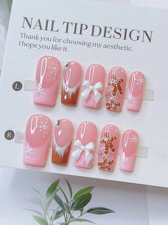 10 piezas Conjunto de uñas postizas con forma de tubo estilo Y2K - Hechas a mano, uñas marrones, uñas rosas, uñas con puntas francesas rosa y marrón, diseño de copos de nieve y hombres de jengibre de Navidad dibujados a mano, decoración de elementos navideños dibujados a mano, con detalles de cristales brillantes, perlas blancas y lazos blancos - Adecuado para mujeres y niñas, fiestas, bodas, uso diario