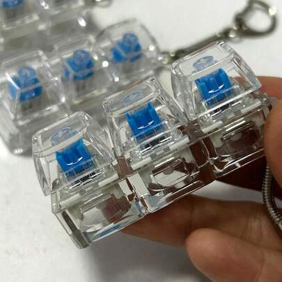 1 pieza Juguete de alivio del estrés, juguete de relajación con tapa de teclado mecánico, llavero y accesorio de escritorio