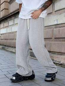 1 szt. Luźne, sportowe spodnie męskie, minimalistyczny, jednolity kolor, szerokie nogawki, ściągacz w pasie, duże kieszenie, odpowiednie do codziennego chodzenia, pracy, podróży itp. "Ze względu na różnice w partiach produkcyjnych mogą występować pewne różnice w kolorach".