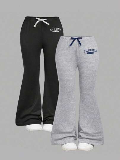 2 st. utsvängda byxor med bokstavstryck och rosettdekor för flickor