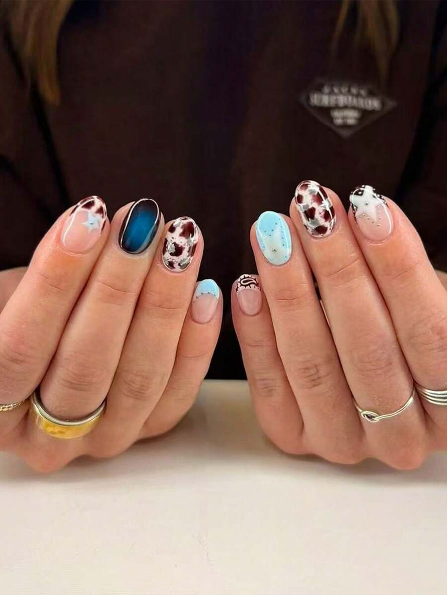 24片短椭圆形3D凝胶美甲贴纸，图案包括奶牛纹、蓝色法式美甲、豹纹、波点和3D凝胶星星设计、粉色公主风，完美适配亚克力甲片，包含1瓶果冻胶和1把指甲锉，适合女性和女孩日常、旅行和派对美甲。 - 查看 1