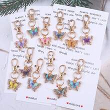 12个“拥抱与爱”口袋拥抱代币，口袋拥抱卡片。附赠励志蝴蝶钥匙扣套装，适合装饰背包、手提包和车钥匙，男女皆宜。这款独特的魅力礼物充满激励和鼓舞，适合任何需要支持和肯定的人。也可作为纪念礼物、友谊礼物、情人节礼物、返校礼物和毕业礼物。 - 彩色 - 查看 14