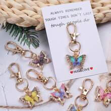 12个“拥抱与爱”口袋拥抱代币，口袋拥抱卡片。附赠励志蝴蝶钥匙扣套装，适合装饰背包、手提包和车钥匙，男女皆宜。这款独特的魅力礼物充满激励和鼓舞，适合任何需要支持和肯定的人。也可作为纪念礼物、友谊礼物、情人节礼物、返校礼物和毕业礼物。 - 彩色 - 查看 3