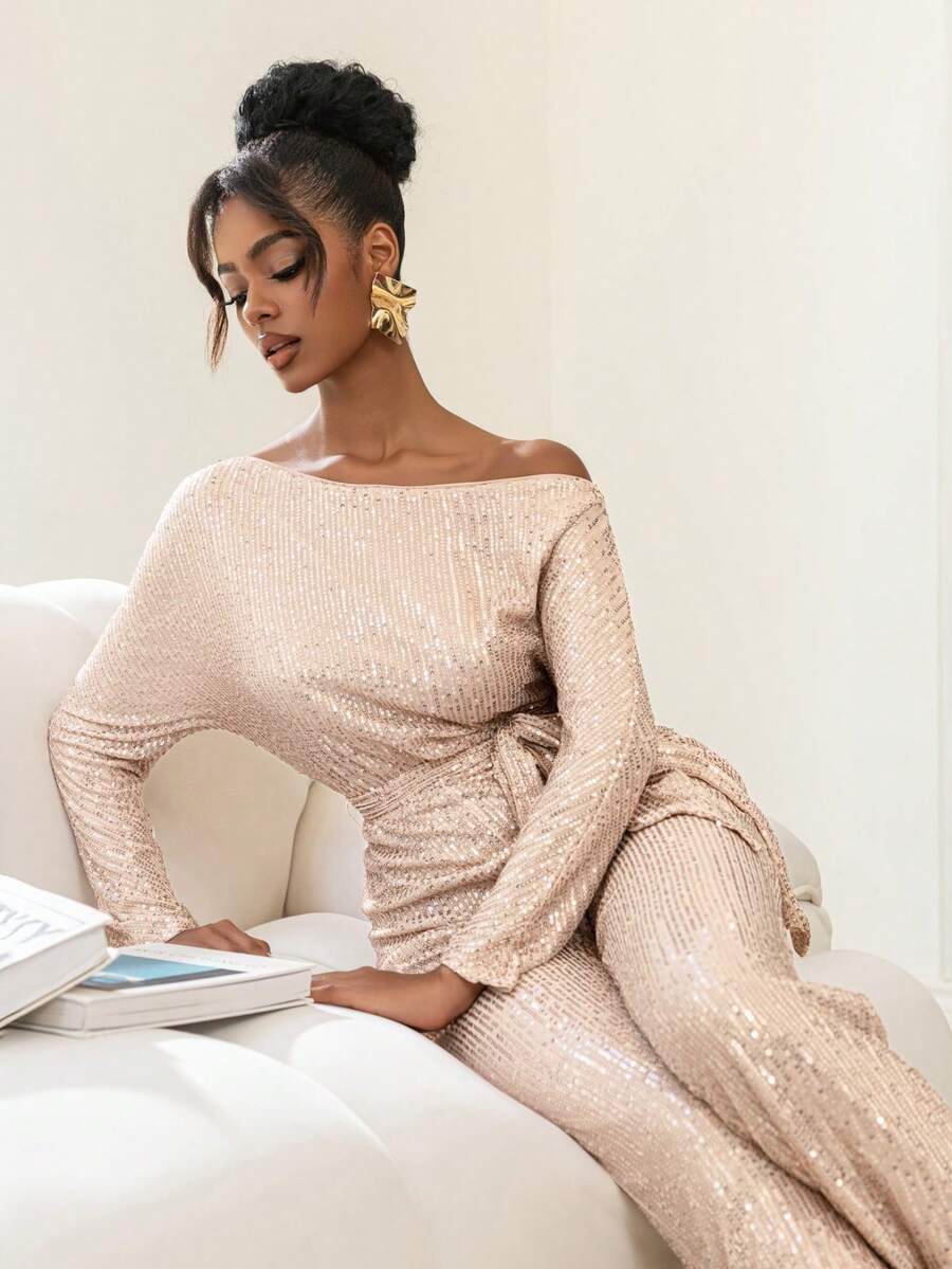 Faeriesty Bộ jumpsuit dài tay bất đối xứng độc đáo này có thiết kế đính sequin lấp lánh, kết hợp với thắt lưng nơ bằng satin và kiểu dáng ống rộng, là lựa chọn lý tưởng cho các sự kiện theo chủ đề vũ trường, dạ tiệc thảm đỏ, tiệc thời trang và lễ kỷ niệm Ngày Valentine. - Rượu sâm banh - Xem 1