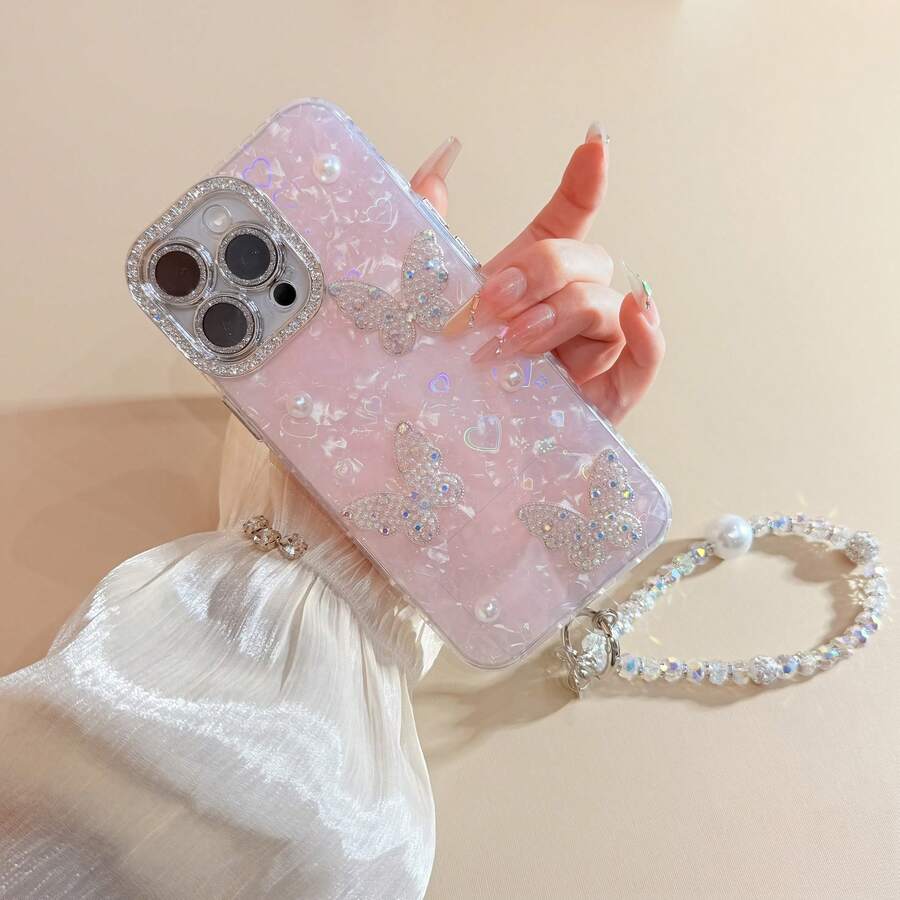 غطاء هاتف وردي اللون بنقشة قوقعة ثلاثية الأبعاد مع حزام معصم متوافق مع أجهزة 17 برو ماكس/17 برو/17، 16 برو ماكس/16 برو/16، 15 برو ماكس/15 برو/15، 14 برو ماكس/14 برو/13 الجديدة