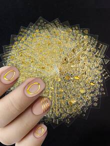 30张金色美甲贴纸，自粘式美甲贴花，图案包括不规则叶子/线条/星星/圆圈/心形/雪花/数字/箭头/几何图案，适合女士奢华美甲 - 金色 - 查看 3