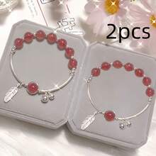 草莓香氛疗愈水晶可爱手链、铃铛羽毛水晶手链、天使水晶珠项链、卡通猫眼友谊项链。这些设计既可爱又优雅，是节日和生日的理想礼物。 - 粉紅色 - 查看 3