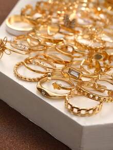 66 piezas Juego de anillos para mujer, con diseños elegantes y minimalistas en tono dorado vintage, que incluyen corazón, mariposa, flor, hoja, gota, geométrico, perla falsa, estrella, rhinestone, onda, trenzado e infinito, para usar en fiestas, días festivos y uso diario - Amarillo Oro - Ver 3