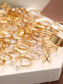 66 piezas Juego de anillos para mujer, con diseños elegantes y minimalistas en tono dorado vintage, que incluyen corazón, mariposa, flor, hoja, gota, geométrico, perla falsa, estrella, rhinestone, onda, trenzado e infinito, para usar en fiestas, días festivos y uso diario - Amarillo Oro - Ver 4