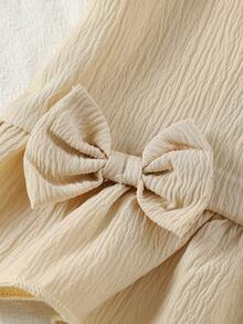 Set de 2 piezas de top de manga corta y shorts de unicolor suave y cómodo con decoración de lazo en tela arrugada para niñas, adecuado para uso al aire libre, primavera/verano - Albaricoque - Ver 6