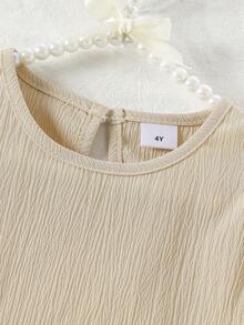 Set de 2 piezas de top de manga corta y shorts de unicolor suave y cómodo con decoración de lazo en tela arrugada para niñas, adecuado para uso al aire libre, primavera/verano - Albaricoque - Ver 3