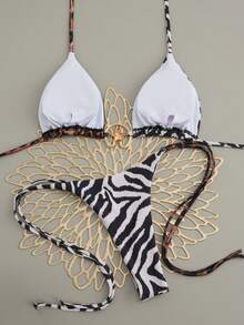 女士性感斑马纹和豹纹细肩带比基尼丁字裤，饰有系带细节和海星图案