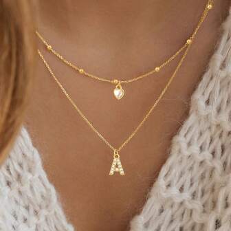 Set de 2 collares de acero inoxidable dorado con colgantes de corazón y cristal artificial con inicial simple y clásica para mujeres