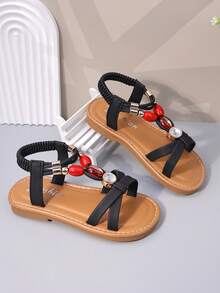 1双黑色哑光软皮女童沙滩凉鞋，交叉绑带设计，饰有闪亮红宝石水钻，后跟配有弹性踝带，圆头，防滑软底，公主风平底凉鞋，适合3-12岁女孩，日常、海滩、学校、度假皆宜，2026春夏款。 - 黑色 - 查看 6
