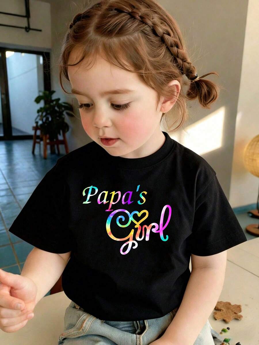 This Is A Soft, Comfy Crewneck T-Shirt For Girls, Suitable For Year-Round Wear. It Features A Sweet "Papa's Girl" Slogan With Colorful Iridescent Lettering & Heart Detail, Boasting A Lovely Father-Daughter Themed Style. Made Of Breathable Polyester Fabric, It's Perfect For Casual Daily Outfits And Father-Daughter Bonding Outings. As A Popular Pick In Kids' Casual Graphic T-Shirts (Children's Daily Fashion), It Also Works Great As A Warm Father-Daughter Gift Outfit. - màu đen - Xem 1