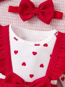 This Baby's Spring/Summer Outfit Features A Triangle Bodysuit With A Pinafore Dress. The Inner Layer Is Covered In Heart Patterns, While The Outer Pinafore Dress Is Adorned With A Large Bow And Layered Ruffles At The Shoulders. Paired With A Matching Headband, It's Perfect For Valentine's Day, Family Gatherings, Or Everyday Outings. - Red - View 4