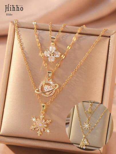 Hihho 3 piezas Collar de Navidad de 3 capas, incrustado con colgantes de planeta, copo de nieve, trébol de cuatro hojas y flor de cuatro pétalos - Regalo de joyería navideña dorada para mujeres