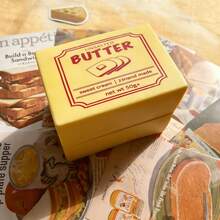 1个柔软慢回弹黄油造型捏捏乐玩具，黄色奶油香味，舒适柔软，适合作为圣诞礼物、派对小礼物或解压玩具