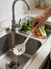 Esta cuchara de espagueti de silicona blanca es resistente al calor y antideslizante. La superficie suave no rayará los utensilios de cocina. Se puede usar para recoger espaguetis y macarrones. El pequeño orificio del mango permite drenar el líquido. El mango de madera está hecho de material de silicona, proporcionando un agarre cómodo y un toque fresco. El mango tiene un orificio para colgar para un almacenamiento fácil. Ya sea para la cocina occidental o italiana, es una herramienta práctica para cocinar pasta. - Multicolor - Ver 5