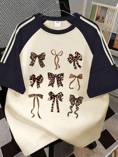 女童豹纹蝴蝶结撞色圆领T恤，舒适柔软运动休闲短袖上衣，适合儿童和青少年，适合春夏季穿着。