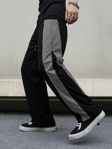 Quần thể thao nam dáng rộng, dài đến mắt cá chân, chất liệu nylon nhăn nhẹ, có dây rút ở eo, phối màu bên hông và đường may nổi bật, phong cách đường phố năng động, phù hợp cho mặc hàng ngày và phối đồ đường phố, là món đồ thể thao thiết yếu cho mọi mùa xuân. - Xám - Xem 6