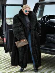 FHILLINUO Elegante lange zwarte jas van imitatiebont in grote maten, normale mouwen, pluizige watervalkraag, warme bovenkleding