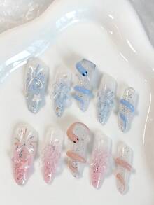 情人节特惠。一套10片长杏仁形手工精致美甲贴片，采用Y2K风格手绘蓝粉渐变色，饰以闪亮细闪粉、烟花、星星和立体树脂花朵。 - 彩色 - 查看 2