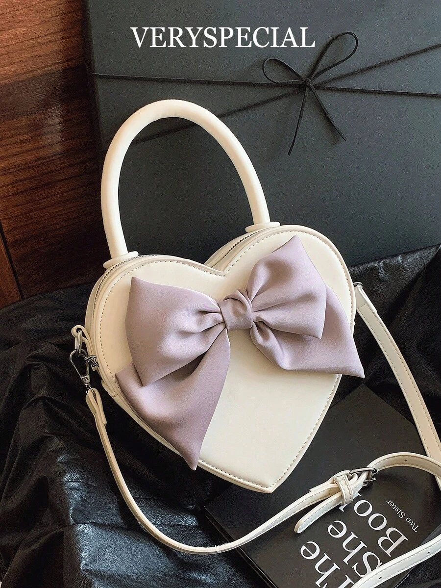 1件酒红色、樱桃红色、心形丝带蝴蝶结装饰可爱韩版女士单肩包、时尚斜挎包，是送给女朋友的理想情人节礼物