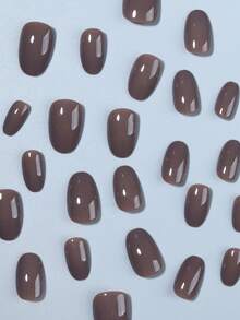 Bộ 24 miếng dán móng tay hình bầu dục ngắn màu nâu bóng, chất liệu acrylic, thiết kế ngắn vừa vặn với móng giả, bao gồm: 1 miếng gel dẻo và 1 dũa móng, thích hợp cho phụ nữ và các bạn gái sử dụng hàng ngày khi đi làm, học tập và các buổi gặp gỡ. - màu nâu - Xem 2