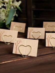 20/10Pcs Love-Themed Wedding Seat Card Holder, With A Refined Metallic Design That Can Be Reused. Made Of Metal, This Heart-Shaped Metal Seat Card Holder Features A Simple Retro Style, A Golden Heart-Shaped Double-Ring Structure, And A Hollow Line Design For Securely Holding Seat Card Messages. - Love - View 1