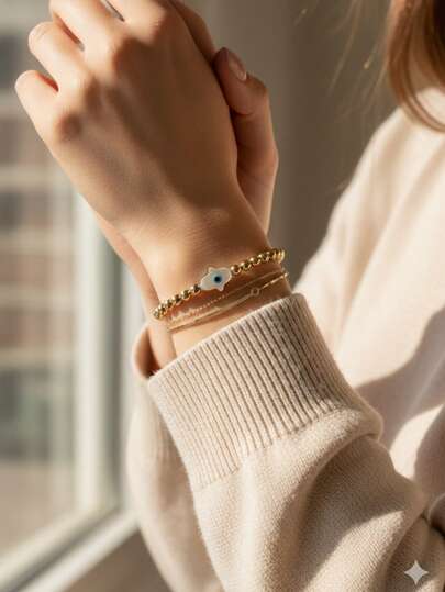  Amaris Joya Pulsera bimetal oro 14k y plata 925 con ojo turco mano de Fatima madre perla elástica dorado