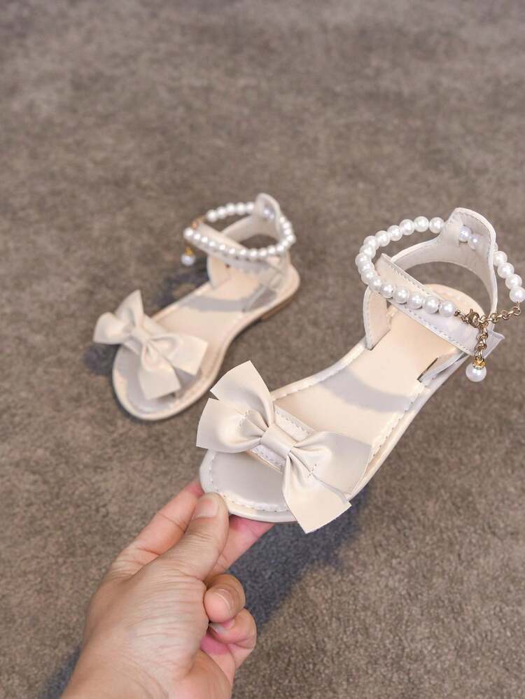 1双女童时尚交叉蝴蝶结装饰可爱甜美凉鞋，休闲平底凉鞋，适合夏季户外、海滩、游乐场穿着，也适合女孩上学、跳舞、日常穿着。 - 米色 - 查看 14